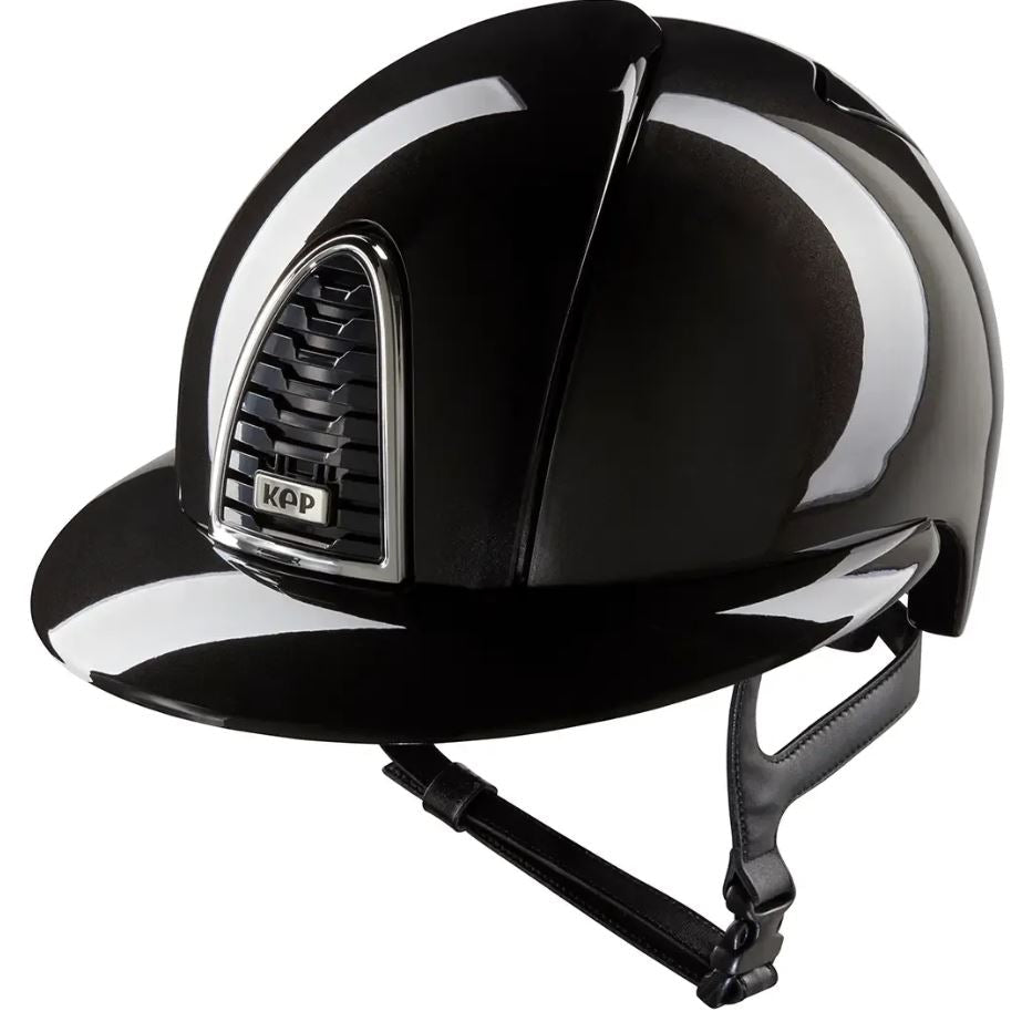 A glossy black equestrian riding helmet with a chin strap, featuring a silver-trimmed vent on the front with a visible KEP logo, set against a plain white background.