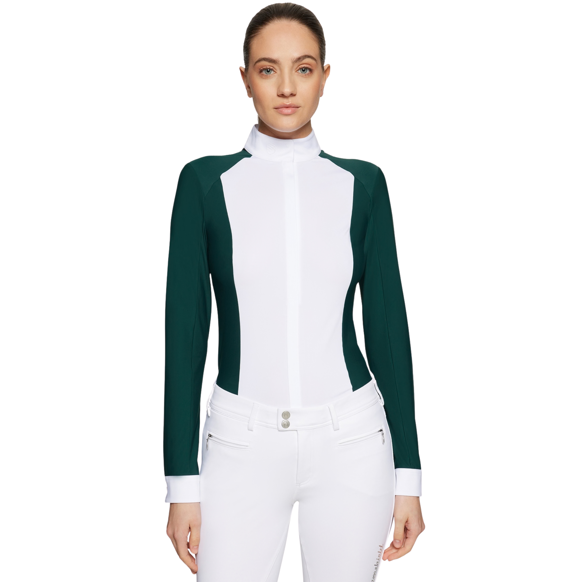 Woman wearing a green and white equestrian top with white pants on a white background