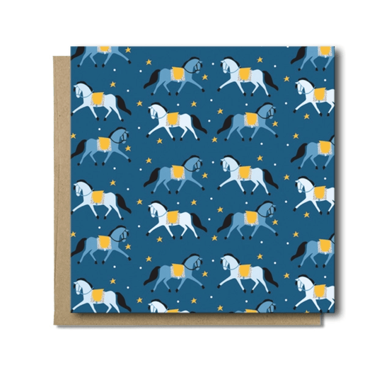 Dressage Pony Pattern Card. Blue background with blue and white horses, yellow stars, and white dots.