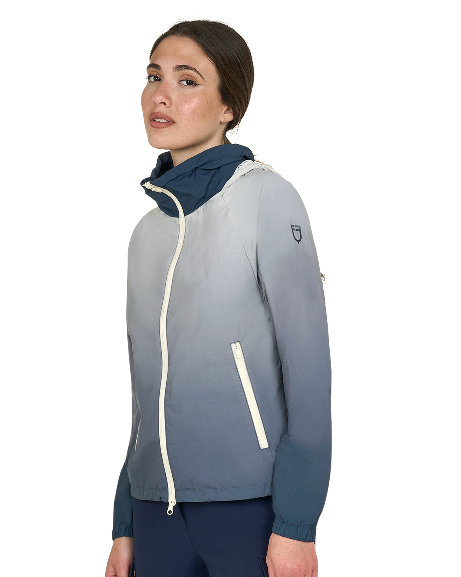 Woman wearing a gray and navy jacket on a white background