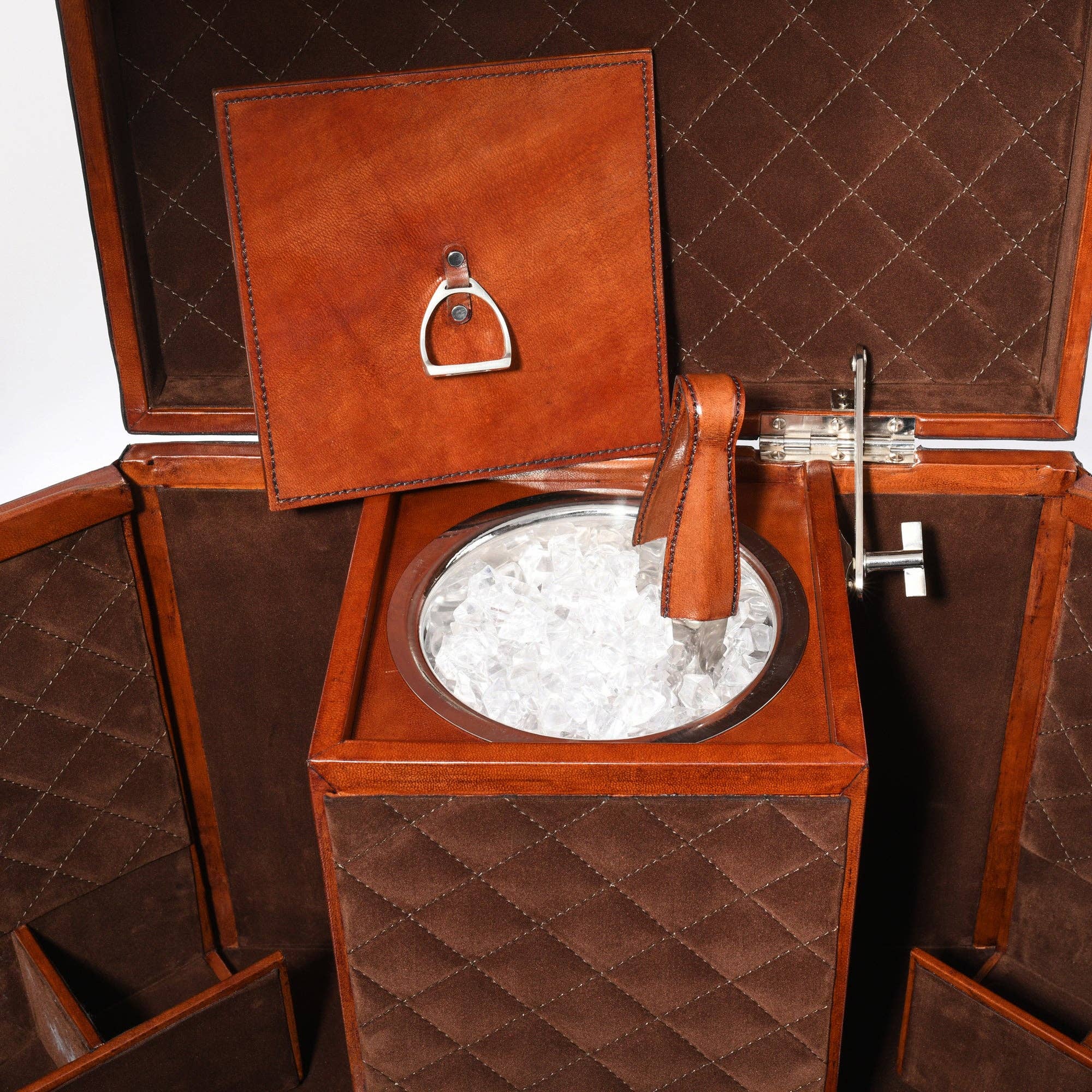 Brown quilted ice bucket with lid and handle, filled with ice cubes, on a matching brown background.