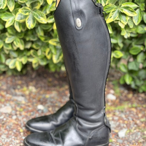 A pair of black leather knee-high riding boots.