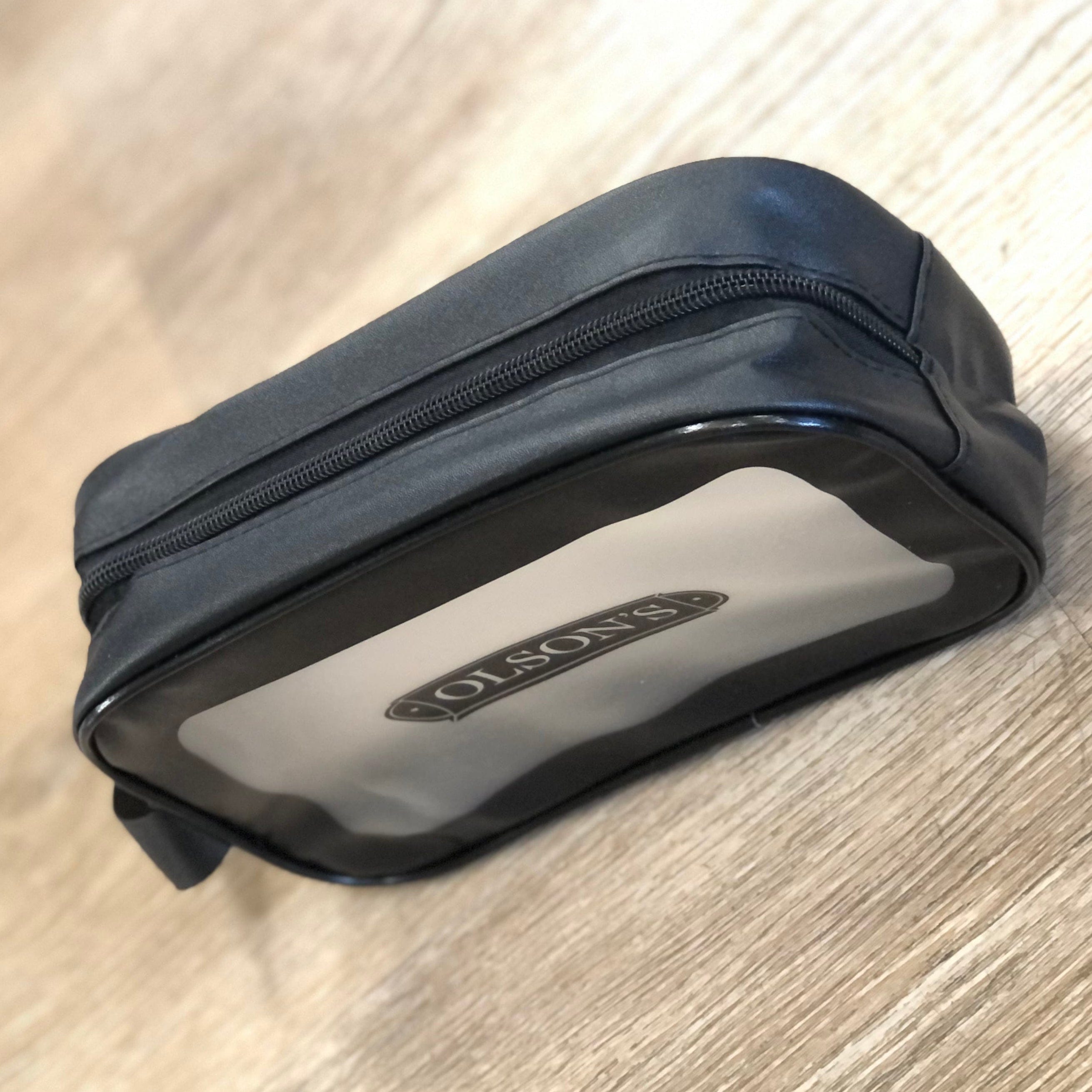 Black toiletry bag with 'Olson's' branding