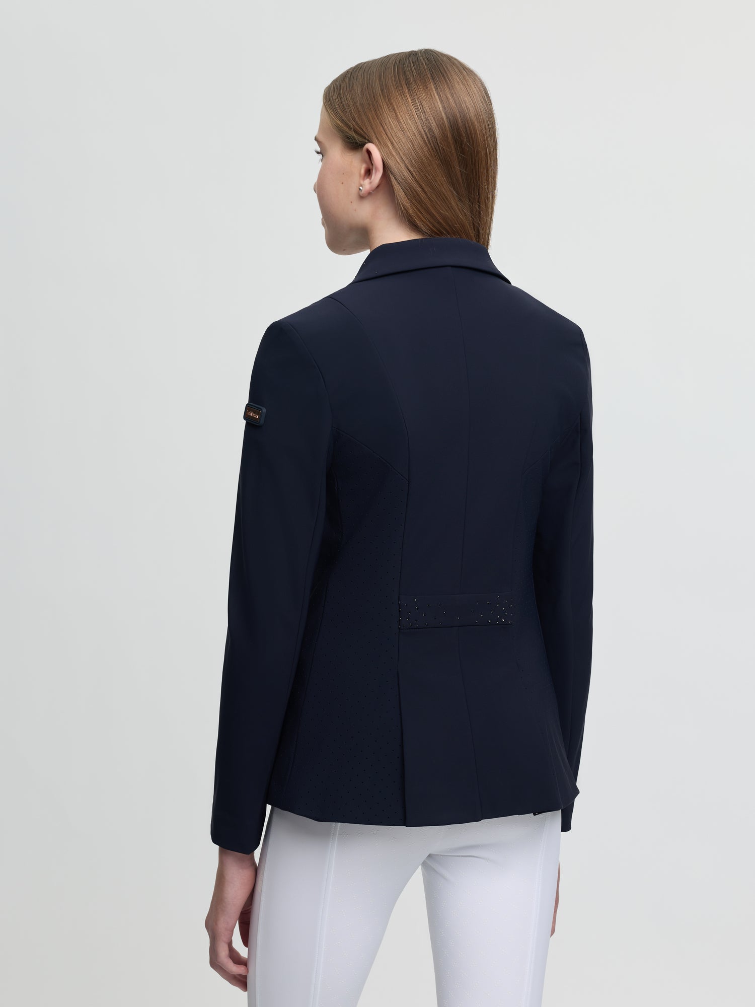 Navy blazer worn by a person on a light gray background