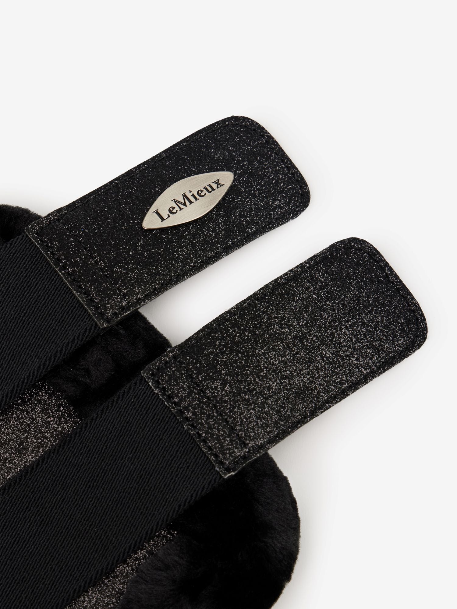 Black equestrian girth with LeMieux logo on a white background