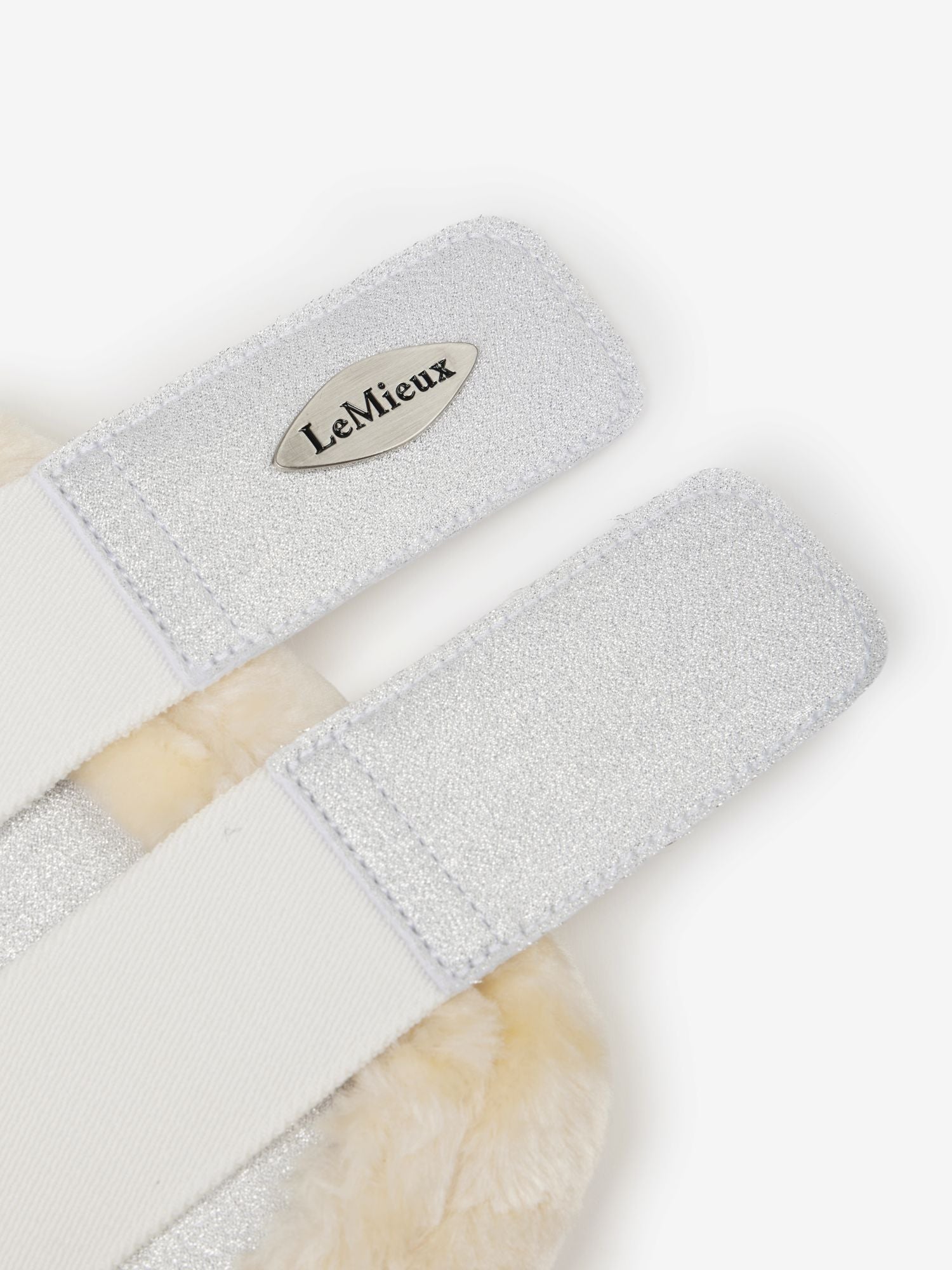 Gray grooming brush with a visible brand logo on a white background