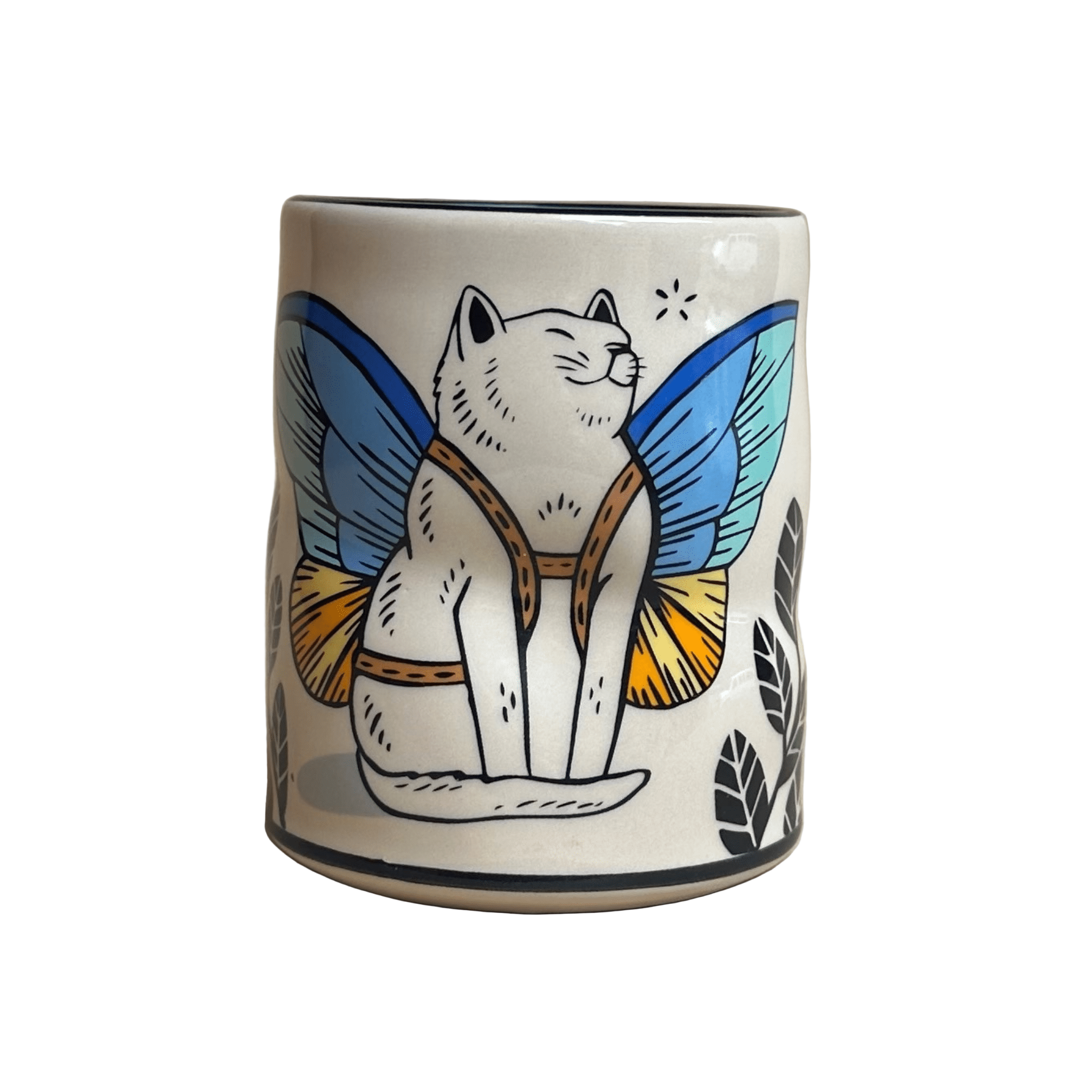 Ceramic mug with a cat design featuring butterfly wings on a beige background