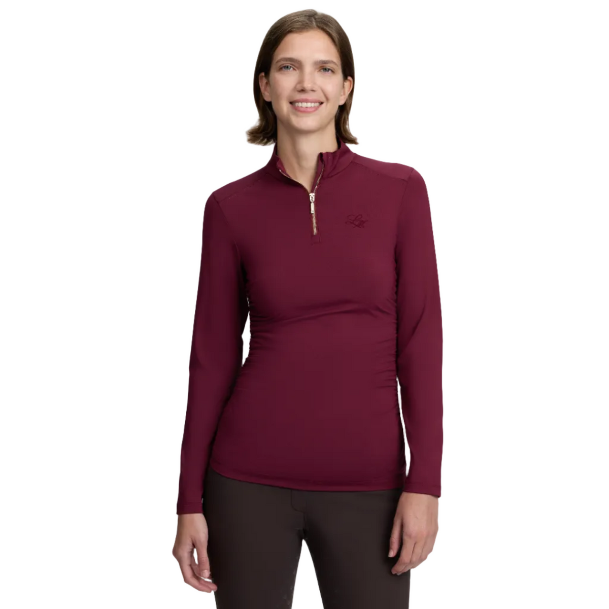 A woman modeling a long-sleeve quarter-zip athletic top in deep burgundy, paired with dark leggings, against a light gray studio background.