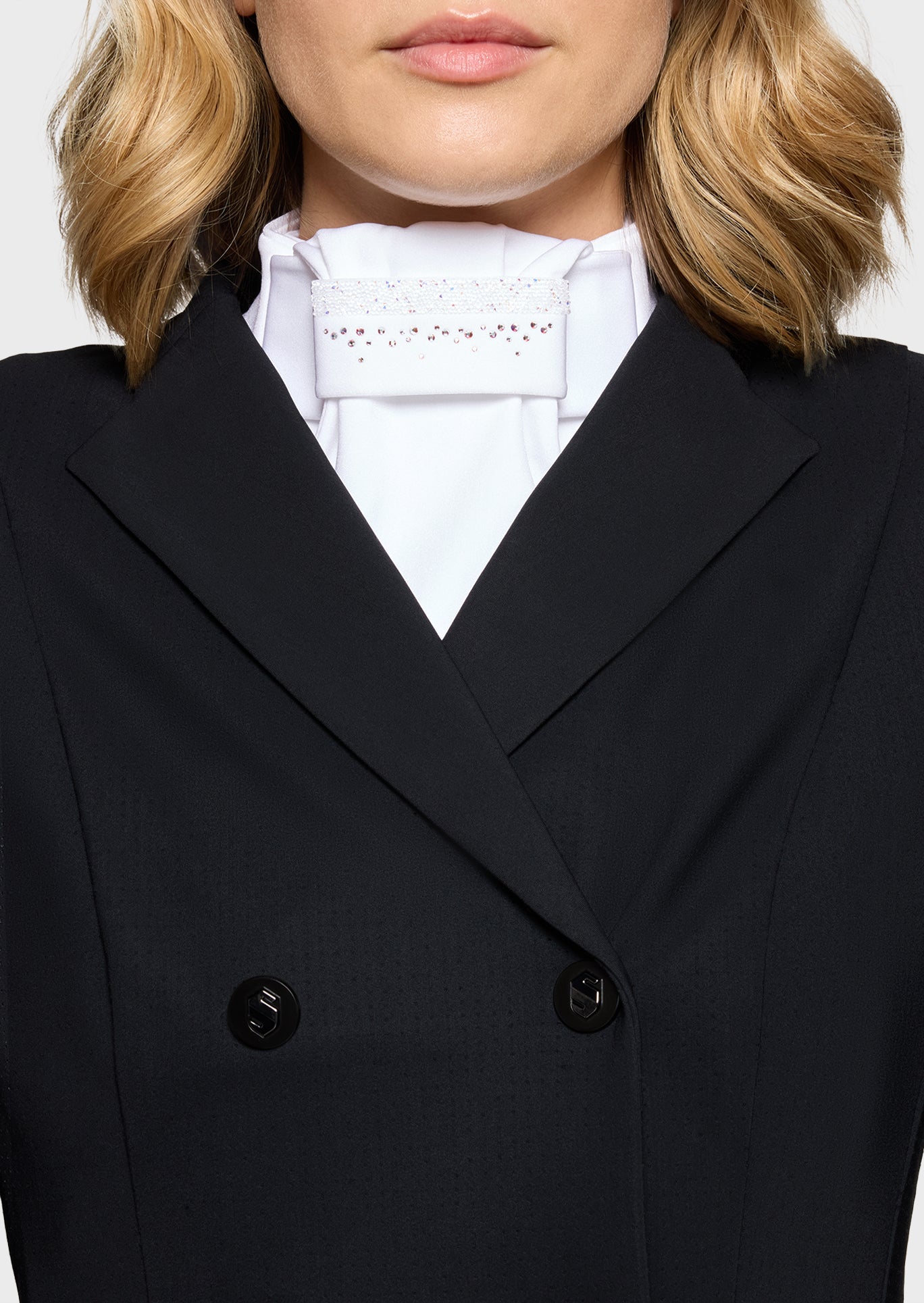 Close-up of a person wearing a black coat with a white shirt underneath.