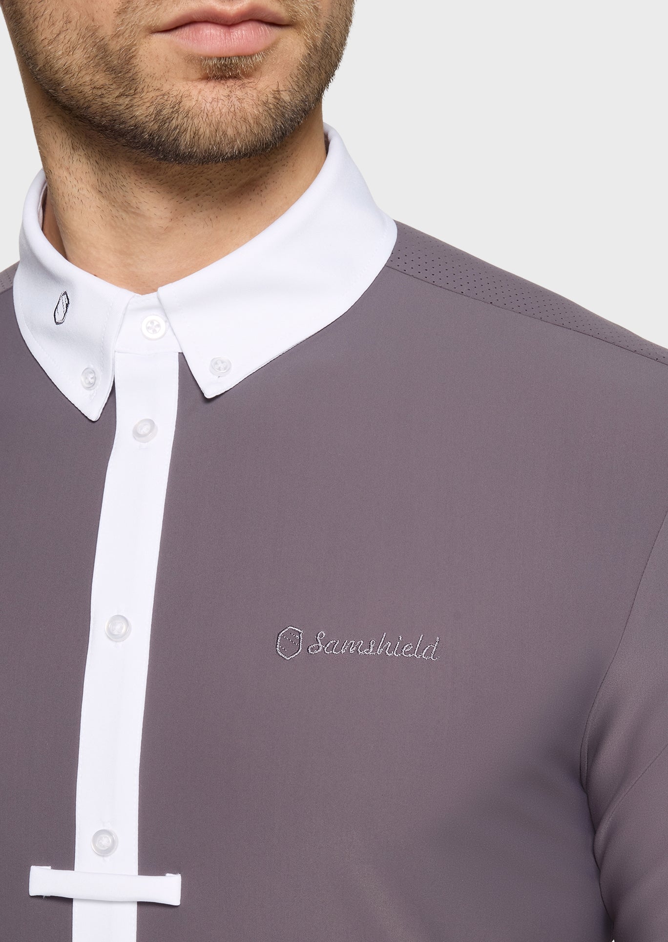Gray shirt with white collar and buttons, featuring a brand logo on a plain background