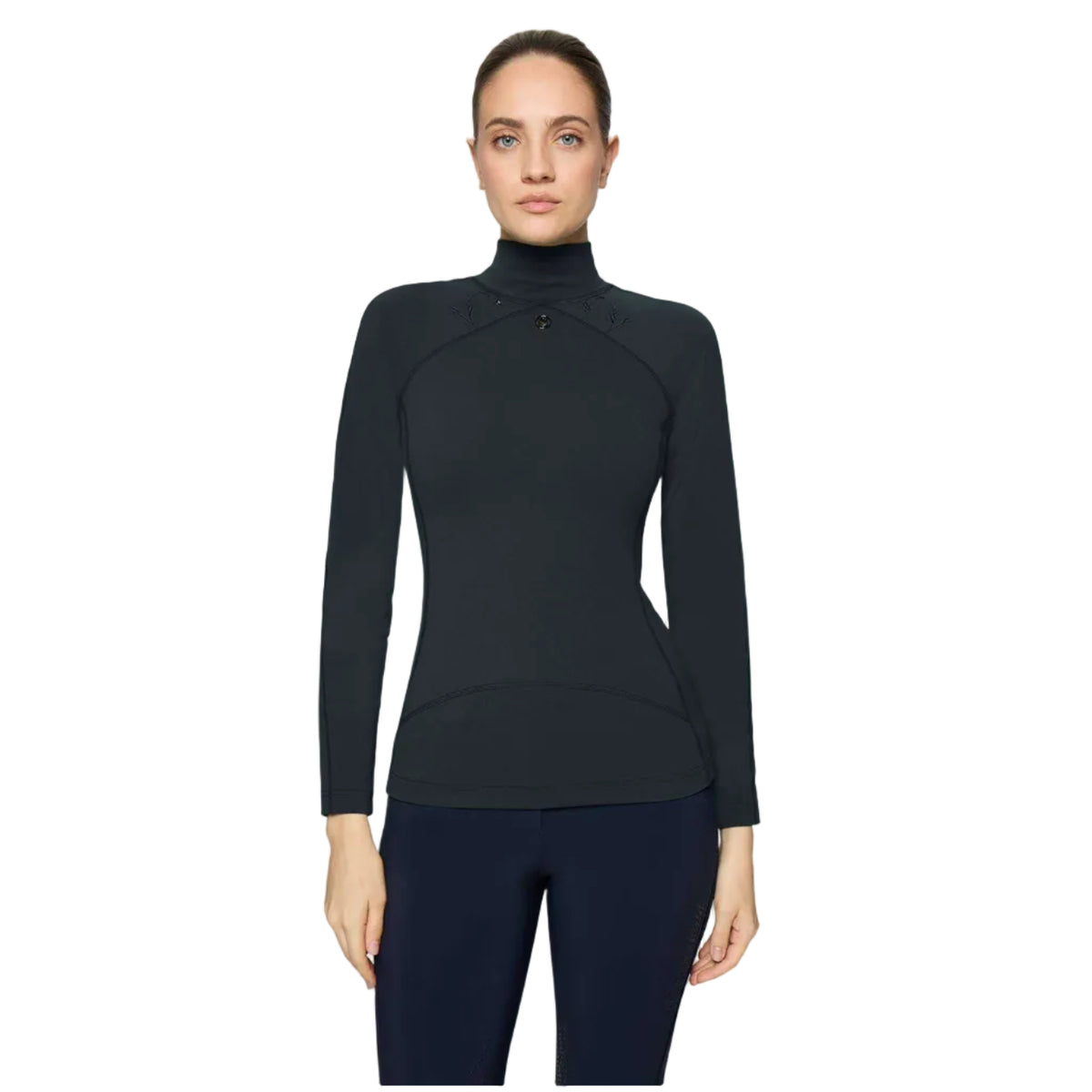 A woman modeling a black long-sleeve mock neck athletic top with a subtle curved seam detail at the waist, paired with dark leggings, against a light gray background.