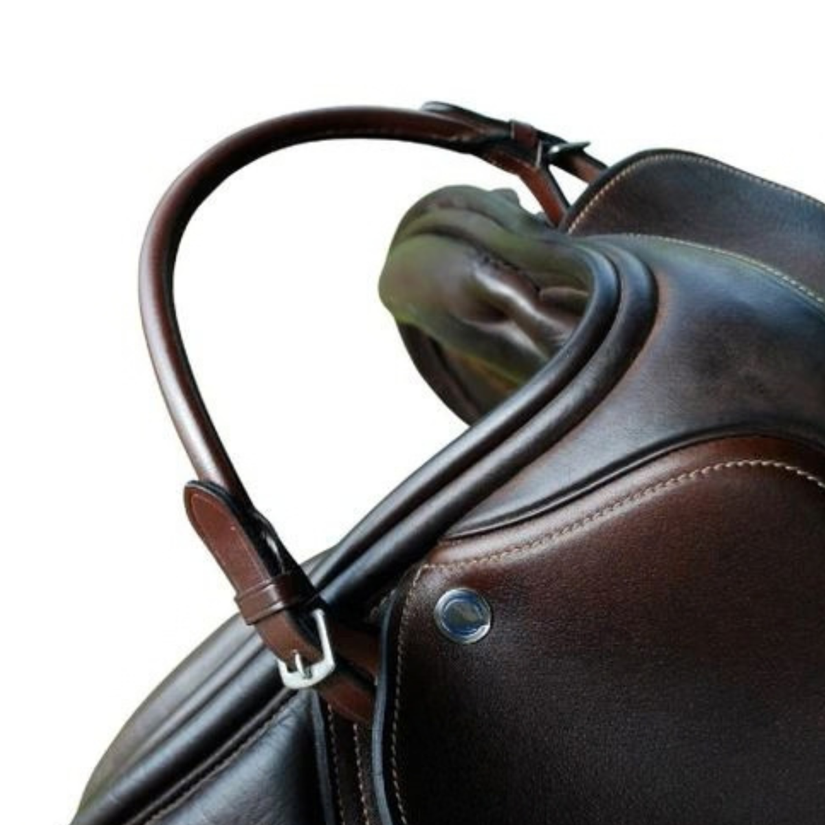 Close-up of a dark brown leather saddle with a curved handle and silver buckle, set against a plain white background.