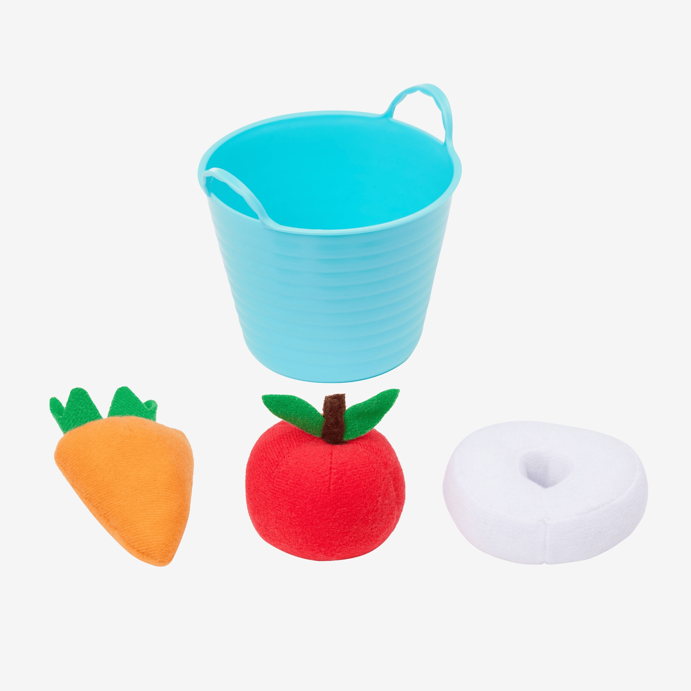 Blue bucket with a carrot, apple, and donut-shaped toy on a white background