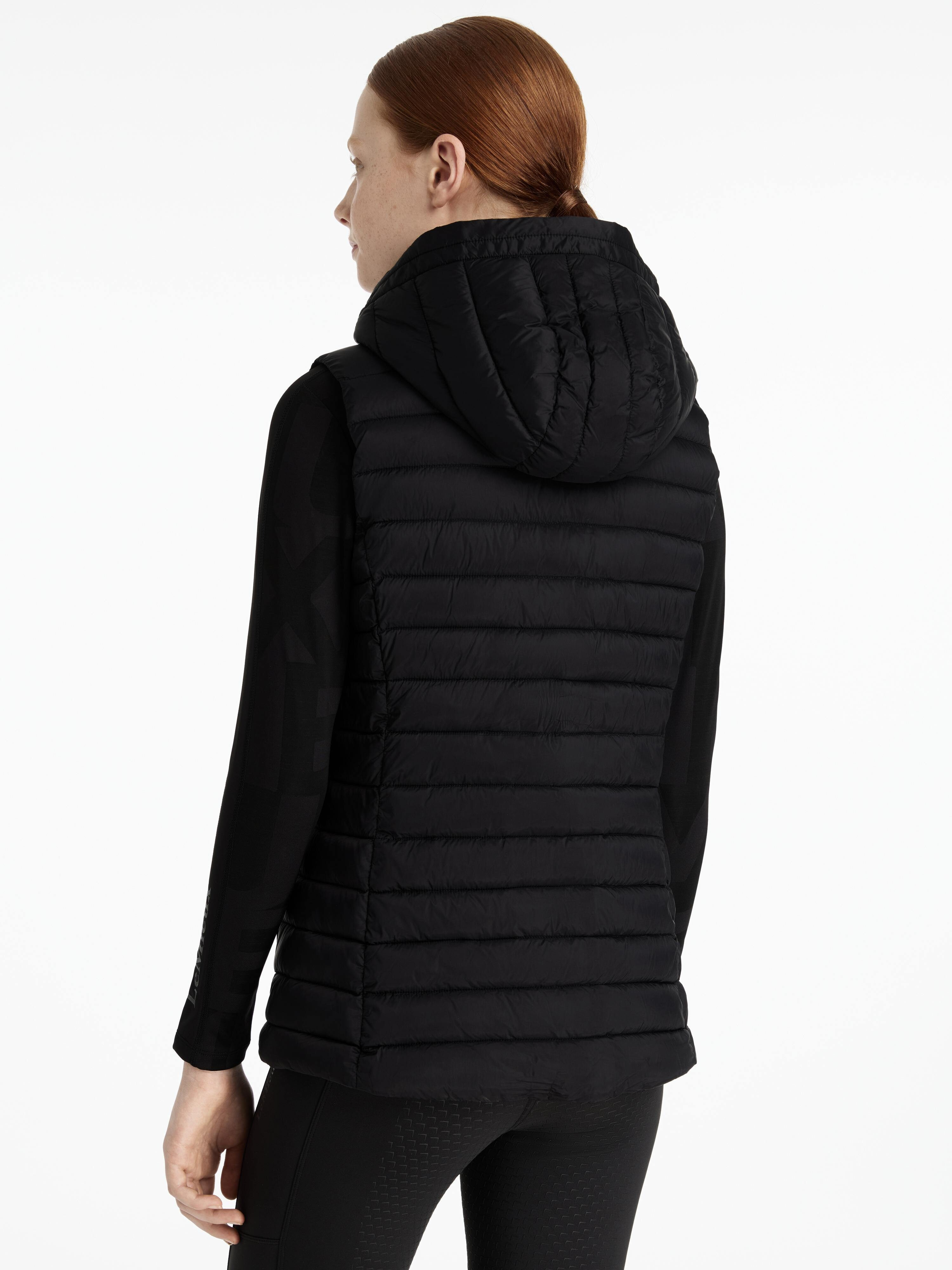 Person wearing a black puffer jacket on a white background