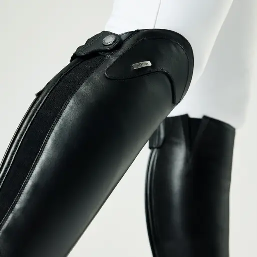 Black protective gear on a mannequin arm with a white background