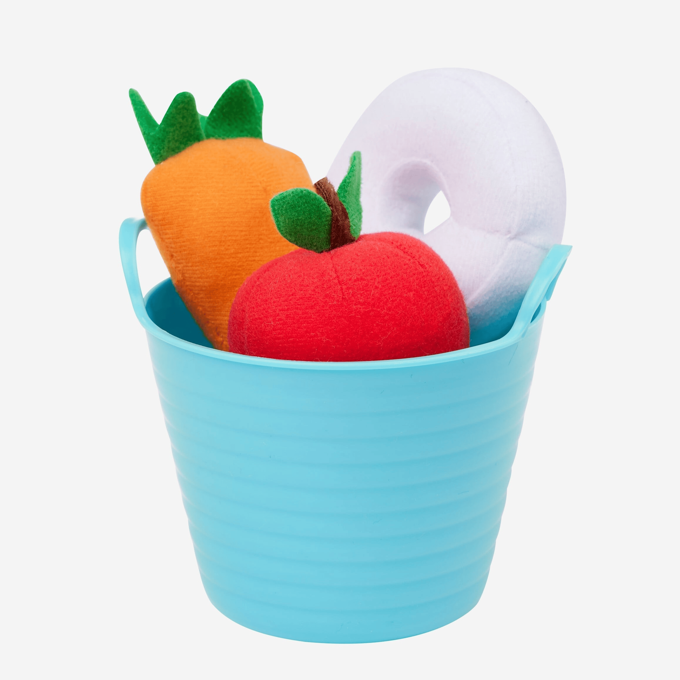 Toy bucket with a carrot, apple, and donut toy on a white background