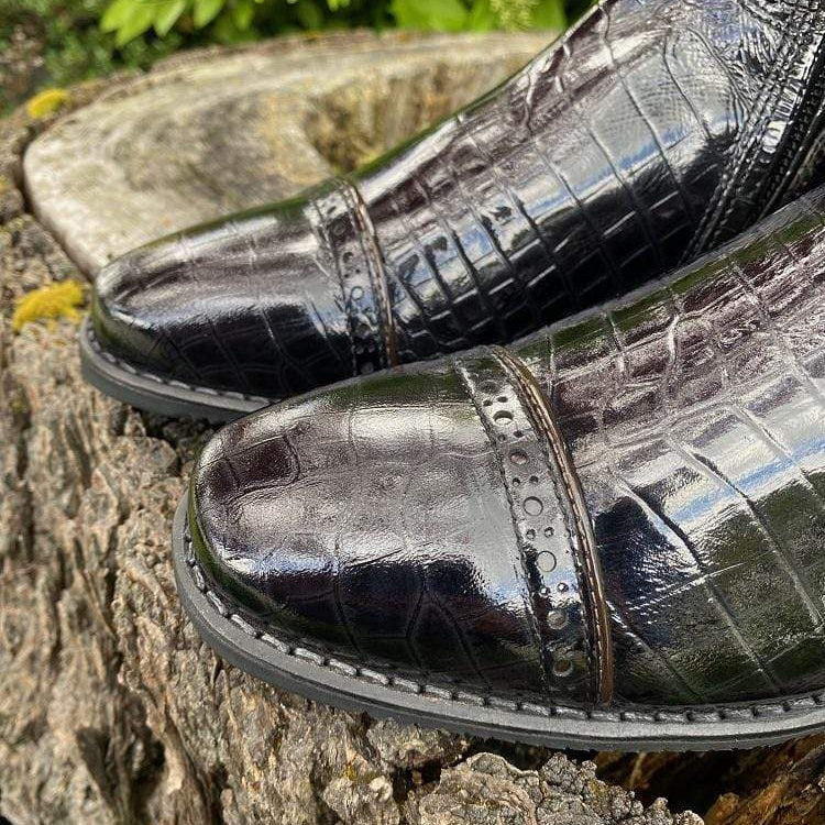 Patent croc foot with punched holes and parent brown rolled toe detailing