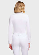 A woman shown from the back wearing a fitted white long-sleeve top and matching white riding-style pants against a light gray studio background.