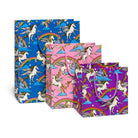 Three colorful gift bags with unicorn and rainbow designs on a white background