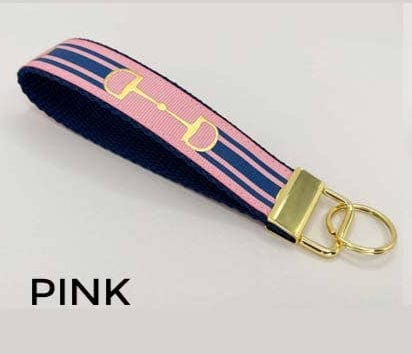 Pink and navy striped key fob with gold hardware on a white background