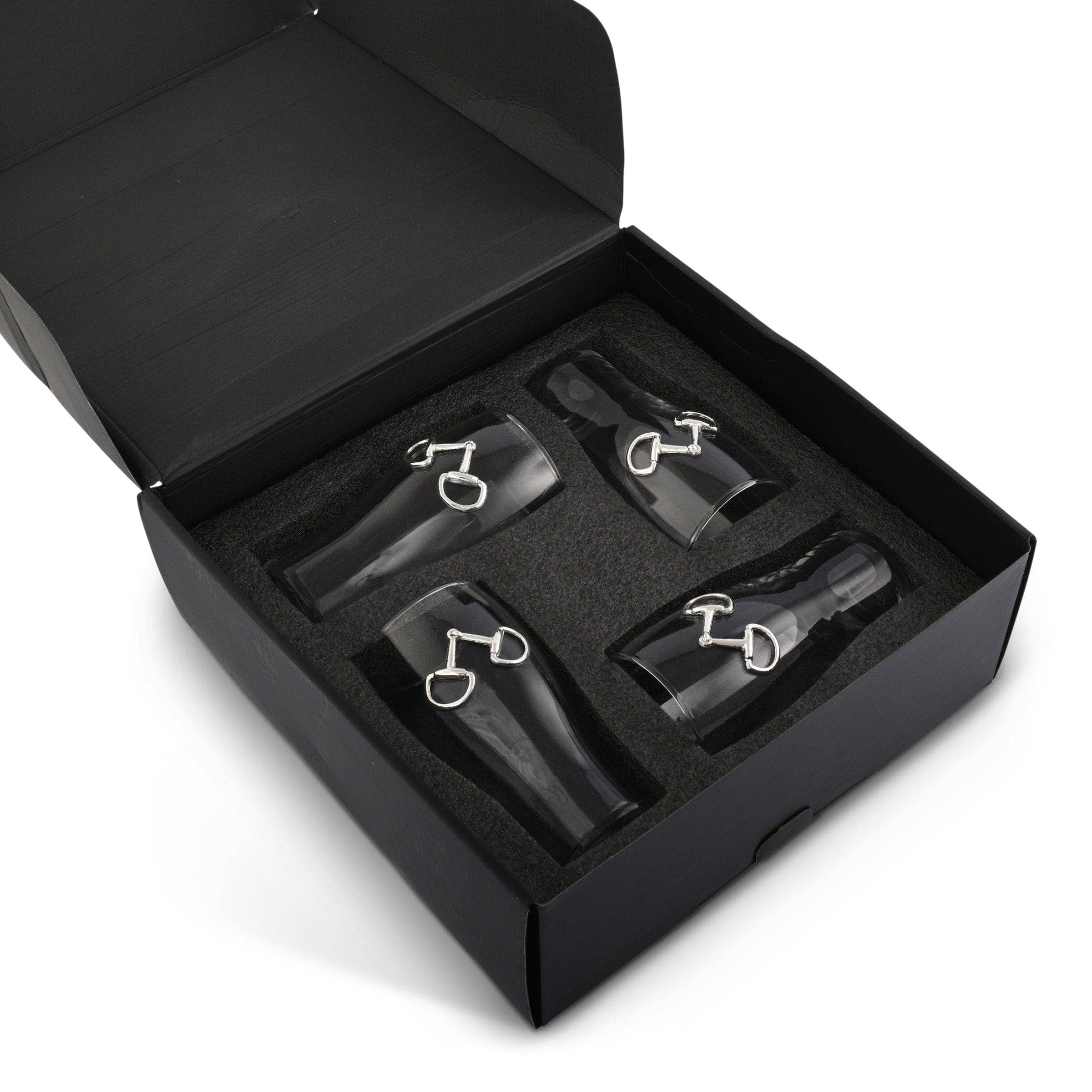 Set of wine glasses with silver accents in an open black box on a white background