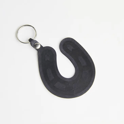 genuine leather keychain in the shape of a lucky horseshoe.