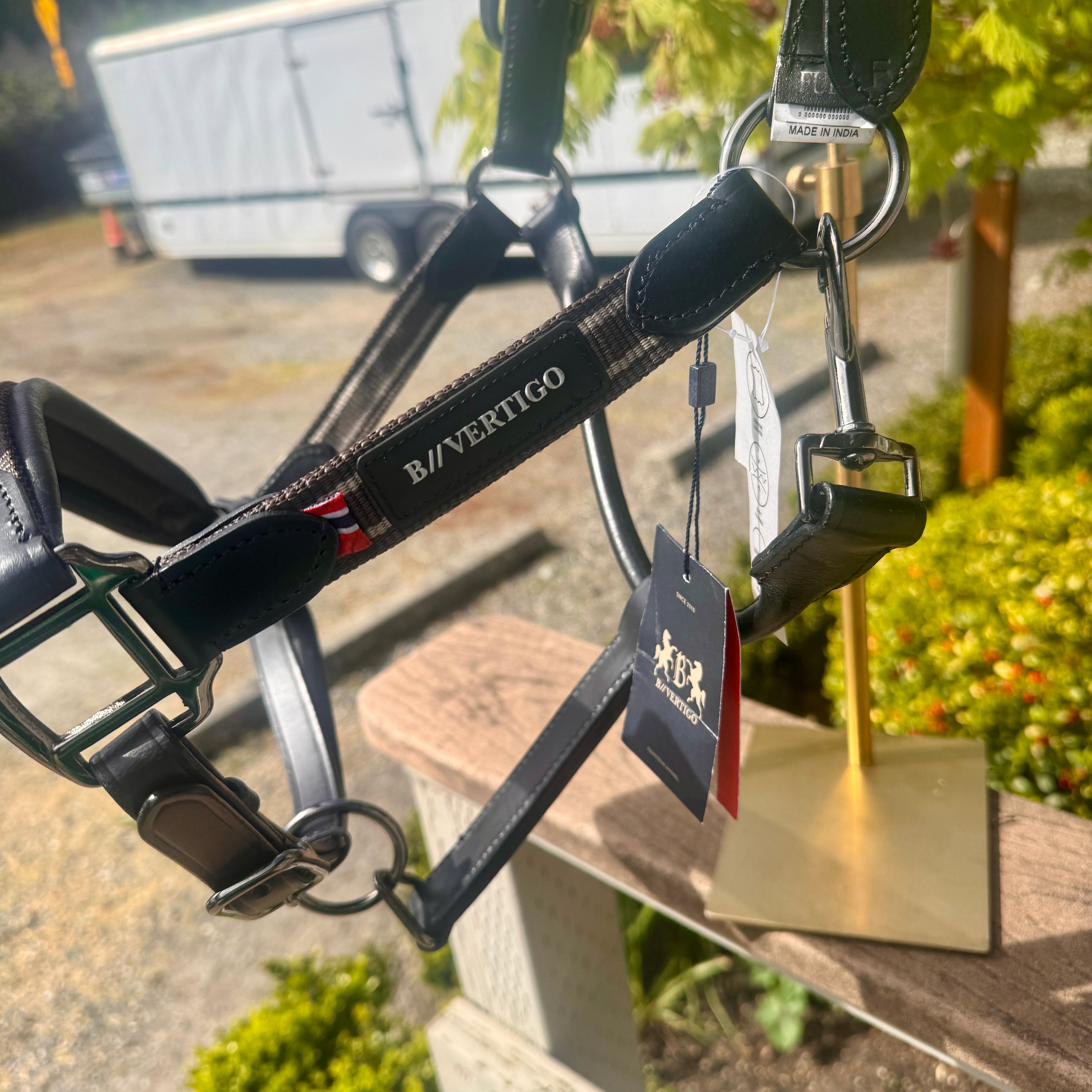 B/Vertigo equestrian halter with tags on a stand outdoors