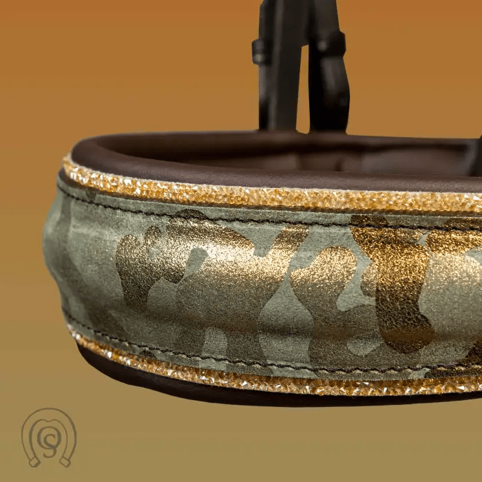 Close-up of a camouflage and gold-accented dog collar with a buckle.