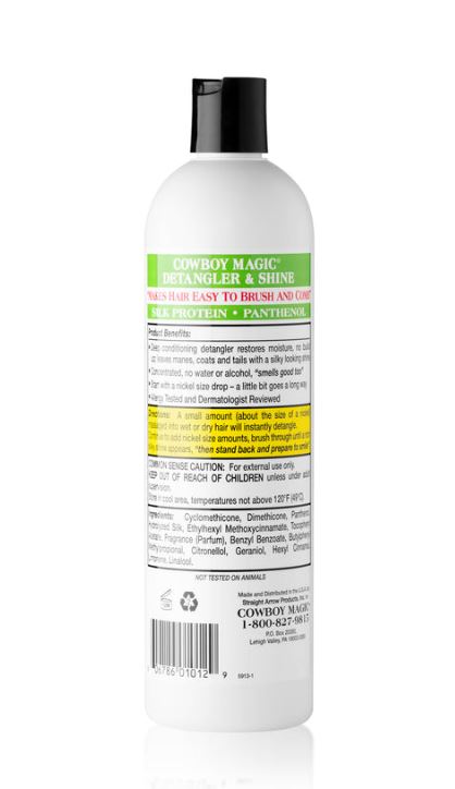 A white bottle of Cowboy Magic Detangler & Shine hair care product with a black cap, shown from the back on a white background with a faint reflection.