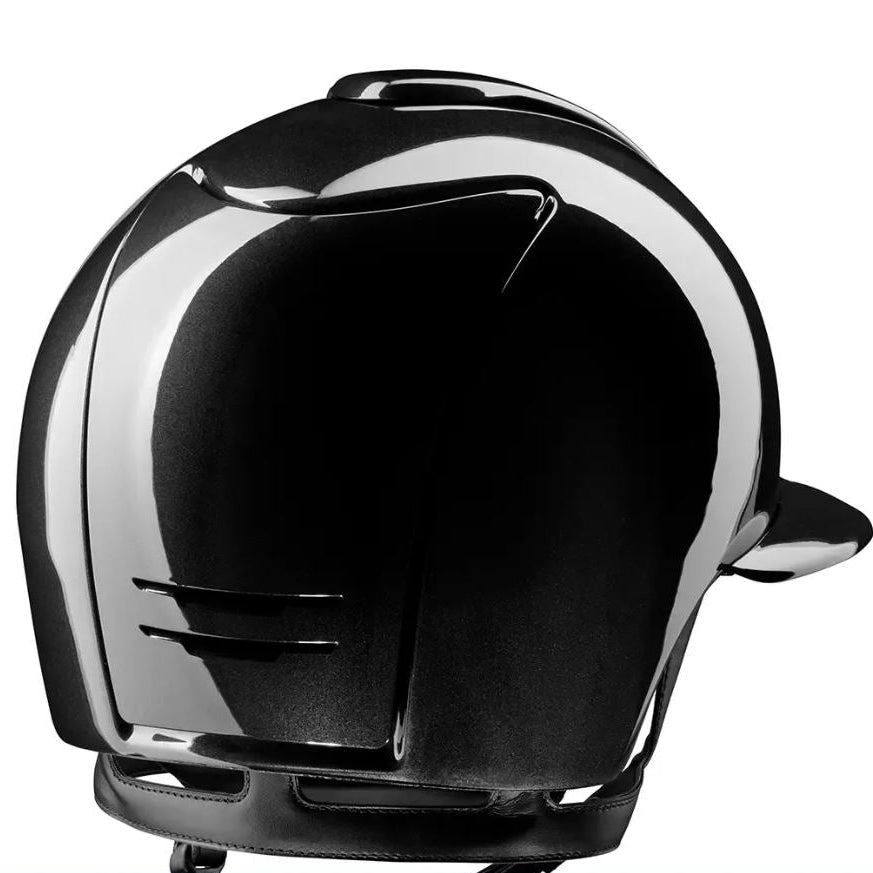 A glossy black motorcycle helmet shown from a rear three-quarter angle against a plain white background.