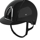 A glossy black equestrian riding helmet with a curved visor and black chin strap, shown on a light gray background. The brand name 'KEP' is visible on the front badge.