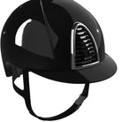 A glossy black equestrian riding helmet with a curved brim and a silver-trimmed vent on the side, shown against a white background.