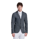 A man modeling a dark gray equestrian sport coat, white breeches, and black riding boots against a light gray studio background.