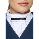 A close-up of a model wearing a white high-collar equestrian neck collar with a sparkling navy blue horizontal band and silver rhinestone accents, paired with a navy blue jacket.
