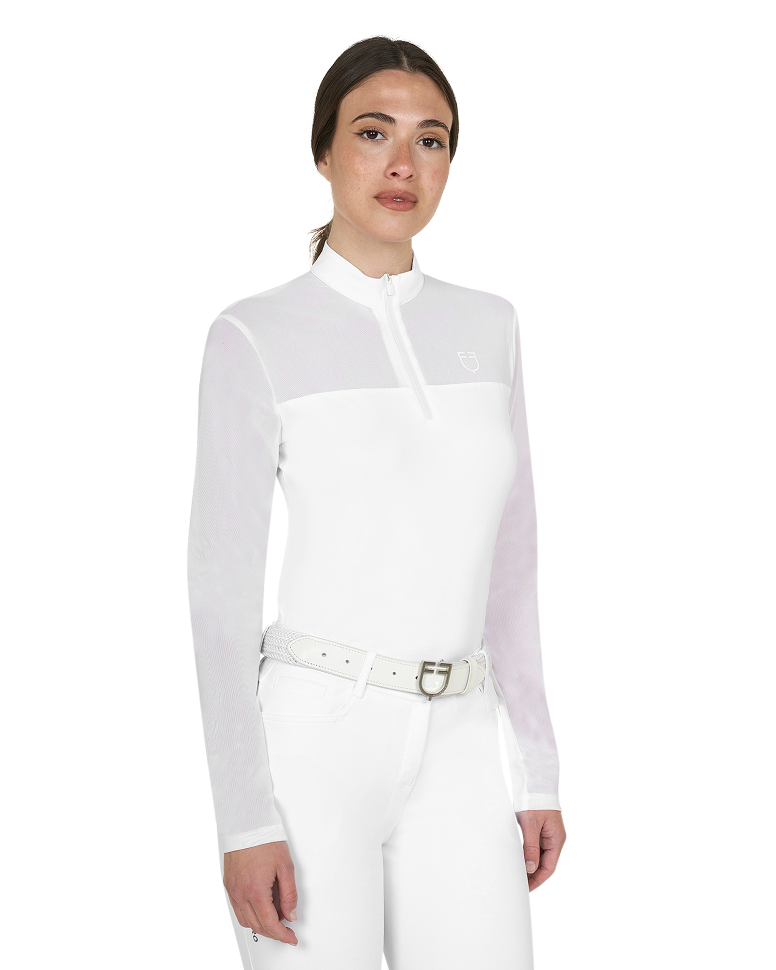 Woman wearing a white equestrian shirt and pants on a white background