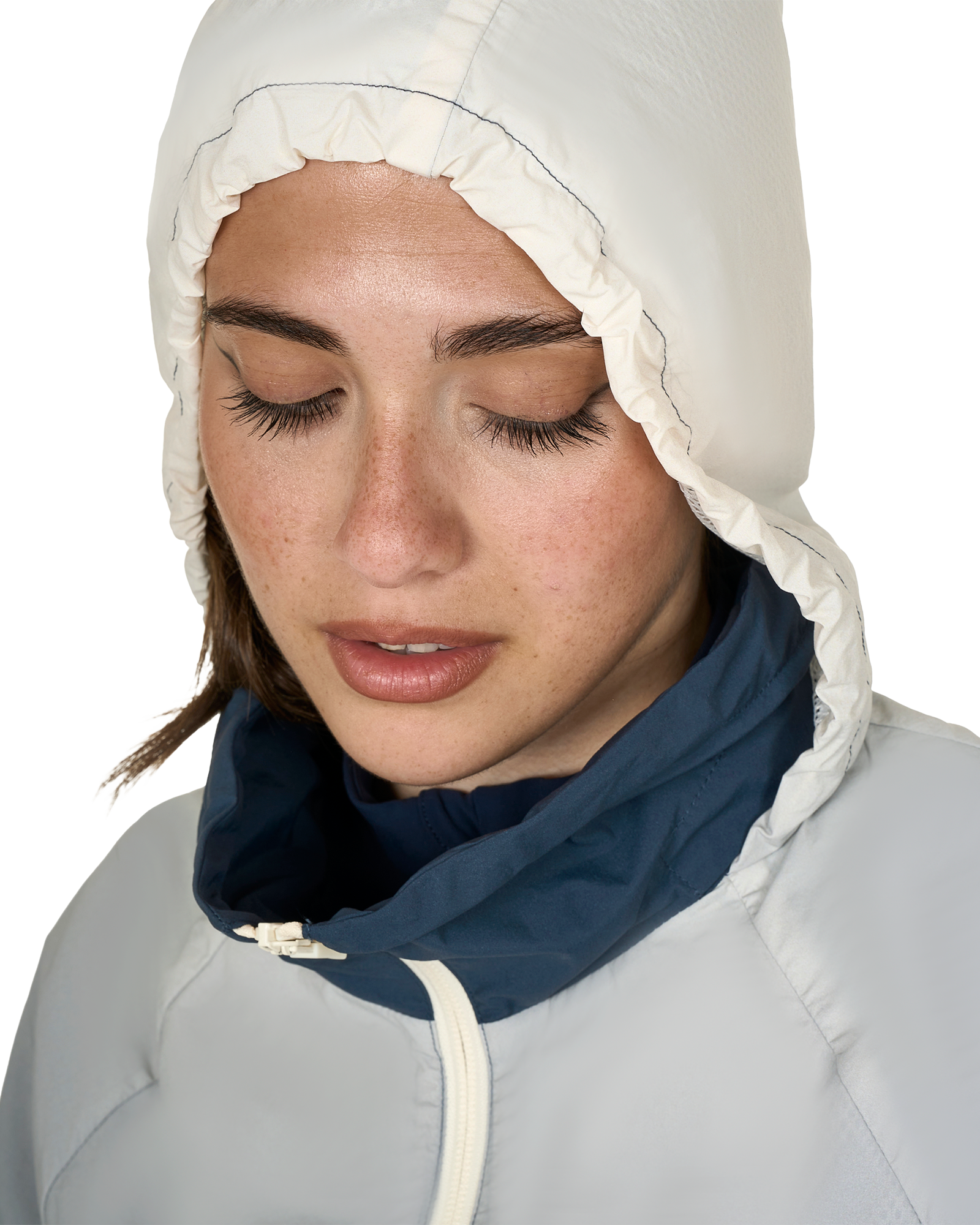 Woman wearing a white hooded jacket against a white background