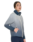 Woman wearing a gray jacket with a blue inner lining on a white background