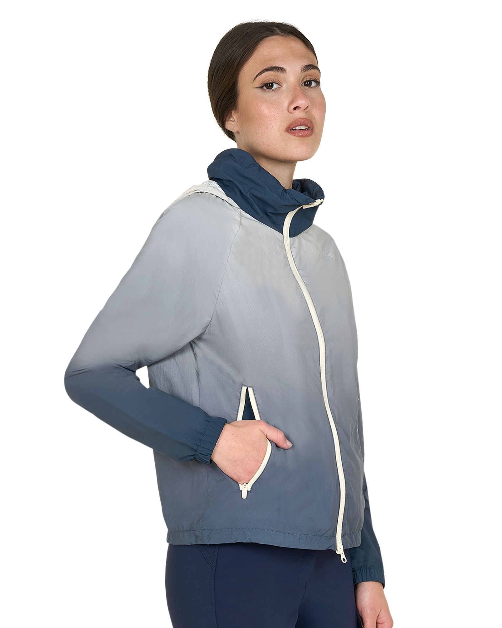 Woman wearing a gray jacket with a blue inner lining on a white background