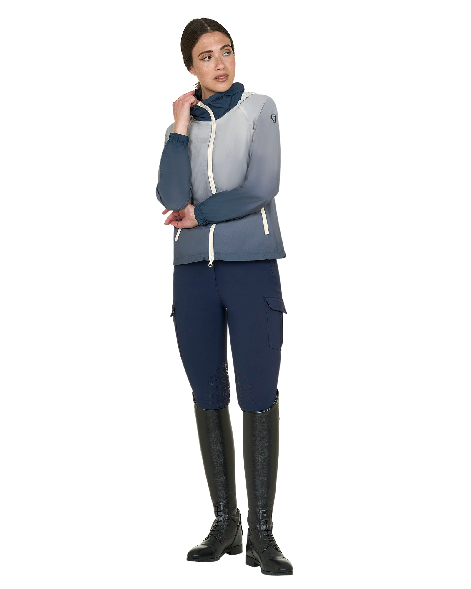 Person wearing a gray and blue equestrian outfit with black boots on a white background