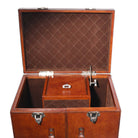 Brown leather trunk with diamond pattern interior on a white background