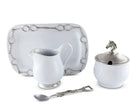 Set of white ceramic tableware with silver accents on a white background