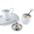 White ceramic creamer and sugar bowl set with silver accents on a white background