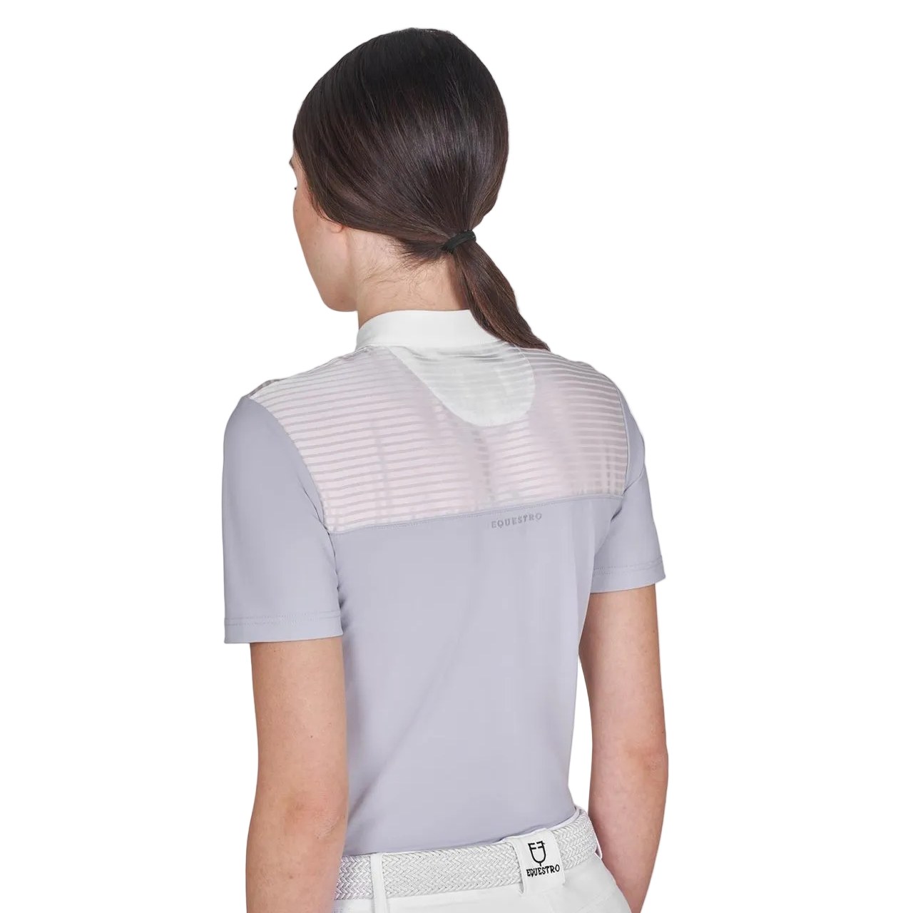 Woman wearing a light grey equestrian shirt with mesh panels on a white background