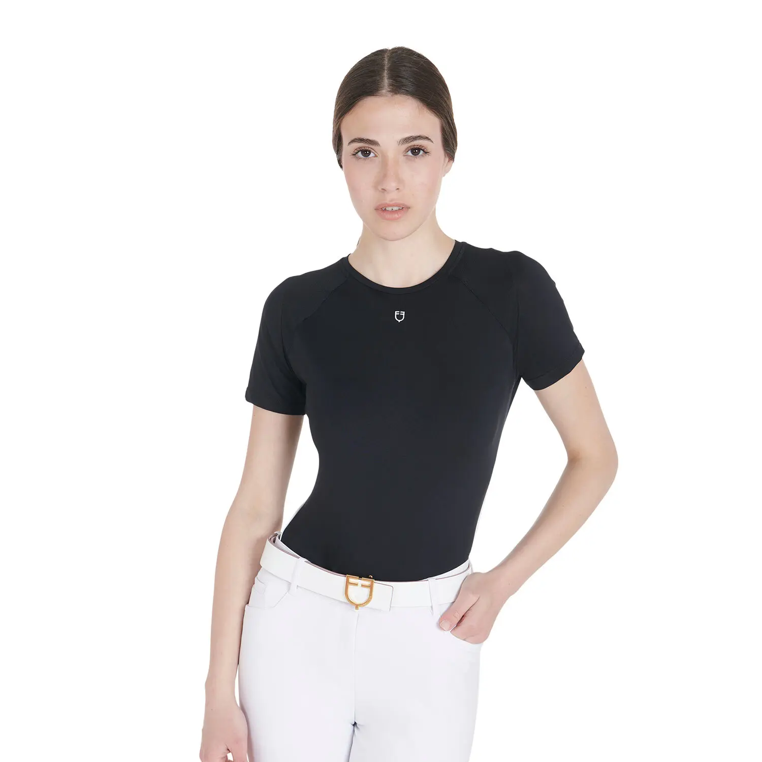 Woman wearing a black t-shirt and white pants on a white background