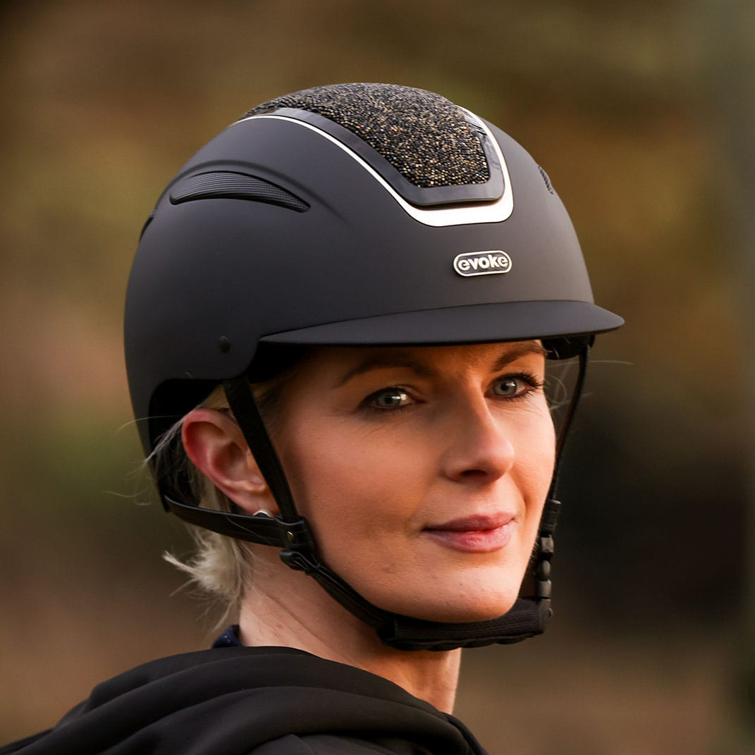 Person wearing a black helmet with a blurred natural background