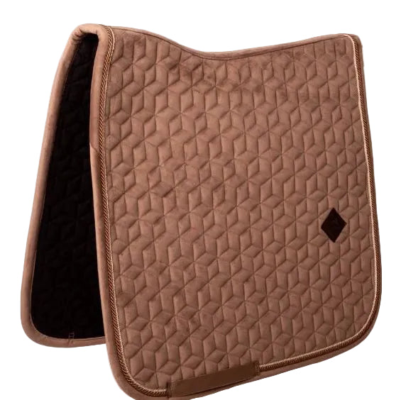 A brown quilted equestrian saddle pad with a geometric pattern and a small dark diamond logo, shown on a light off-white background.