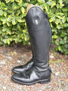 A pair of black leather knee-high riding boots.