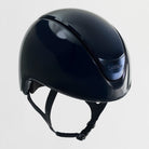 A glossy dark navy blue equestrian riding helmet with black chin straps, shown from a three-quarters angle against a light gray background.