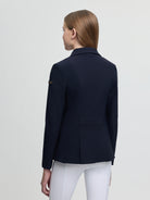 Navy blazer worn by a person on a light gray background