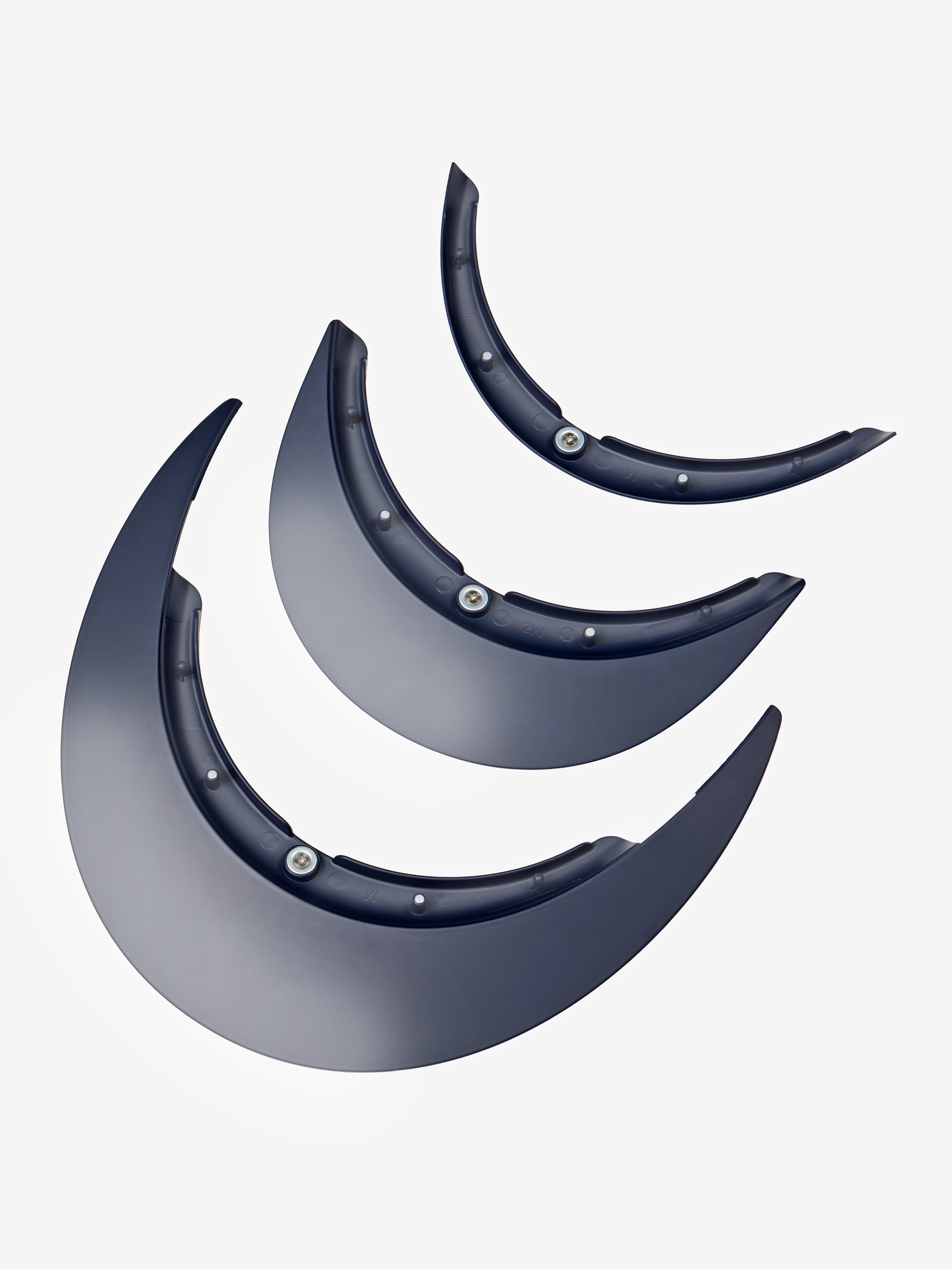 Set of three black fender extensions on a light gray background